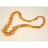 AMBER. An amber bead necklace. Largest bead length 2cm. Approx. 27g.