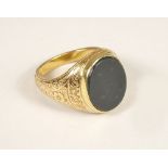 GOLD RING. A gentleman's 15ct. gold engraved signet ring, set a bloodstone. Approx. 8.4g.