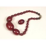 BAKELITE. A short string of brown Bakelite beads, & one loose bead. Largest bead length approx. 3.