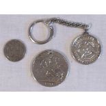 George IIII silver crown coin dated 1821, a 1964 Kennedy half dollar mounted on to a key chain,