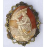 Shell cameo brooch depicting Hebe and the eagle Zeus set into an openwork scroll surround, 8cm high