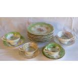 Eight 19th century porcelain dresser plates with hand-painted floral centres and green & gilt