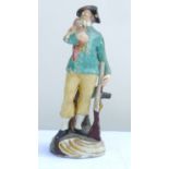 Staffordshire figure of a gamekeeper, with black hat, leaning against his gun and holding a duck, on