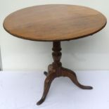 Circular tilt-top table 80cm diameter, on turned support and three shaped legs