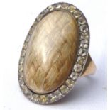 19th century mourning ring, the oval centre, 3cm long, filled with hair, surrounded by clear stones,