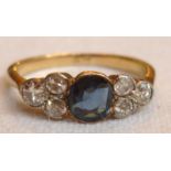 Sapphire and diamond ring, the central sapphire flanked by six diamonds, on gold, approx size L