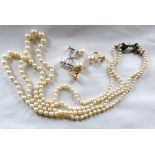 Twin strand graduated pearl necklace with unmarked white metal bow clasp set with blue and clear