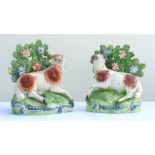 Pair of Staffordshire recumbent rams with floral bocage and painted detail, 11cm high