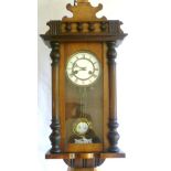 Vienna regulator wall clock in mahogany glazed casing flanked by half-pillars, white enamel circular