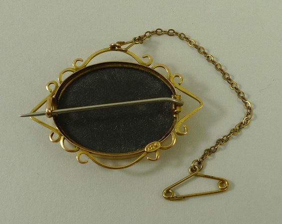 An oval pietra dura brooch, the ground set with flowers and leaves, in 9ct gold scroll form mount, - Image 2 of 2