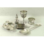 A group of silver items comprising a Danish silver spoon, a Scottish mustard spoon, a tea strainer,