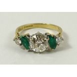 An 18ct gold, diamond and emerald five stone ring, the central old cut diamond of approximately 1.