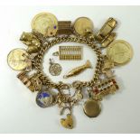 A 15ct gold charm bracelet with twenty five charms, including a gold sovereign 1912,