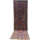 An Azerbaijan runner, with blue ground, dark red, cream and madder geometric decoration,