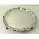 A silver salver, Chippendale piecrust edge, raised on four ball and claw feet, Sheffield 1924,