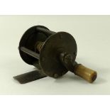 An early English brass fishing reel, the single action winch with four columns to the plates,
