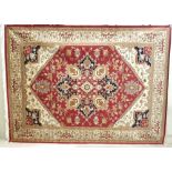 A Heriz rug with red ground, central medallion, cream layered corners,