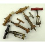 A group of corkscrews comprising two Victorian ratchet action corkscrews with badger's hair brushes,