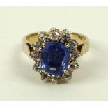 A 9ct gold and sapphire ring in a surround of white sapphires, approximately 3ct, size N, 5.