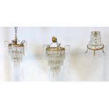 A group of three cut glass chandeliers comprising two vintage ceiling chandeliers and a wall