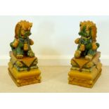 A pair of 20th century Chinese Dogs of Fo, decorated in a Tang style green and amber glaze,