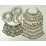 A collection of Arabic white metal Bedouin jewellery, comprising a pair of hoop earrings,
