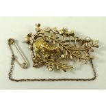 A 9ct gold, seed pearl and ruby brooch formed as a frog amongst ferns, 15.2g total weight.