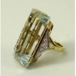 An 18ct gold Art Deco French designer dress ring, the central pale blue untreated topaz 15 by 30mm,