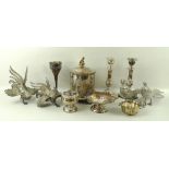 A collection of plated wares, comprising a biscuit barrel with putti finial, a pair of candlesticks,