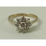 An 18ct gold and diamond flower head ring, the central diamond of approximately 0.