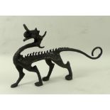 An Art and Crafts bronze figure of a dragon, 15 by 9cm high.