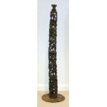 An African hollow carved hardwood figural lamp stand, in four sections on a round base,