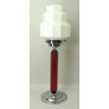 An Art Deco table lamp, with geometric shape milk glass shade,