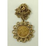 An Edward VII gold half sovereign, 1907, in a 9ct gold pendant mount with gold link chain.