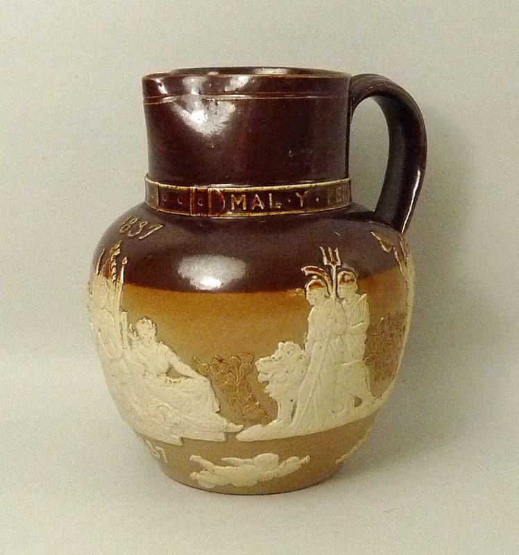 A Doulton Lambeth two-tone stoneware jug commemorating Queen Victoria's Golden Jubilee in 1887,