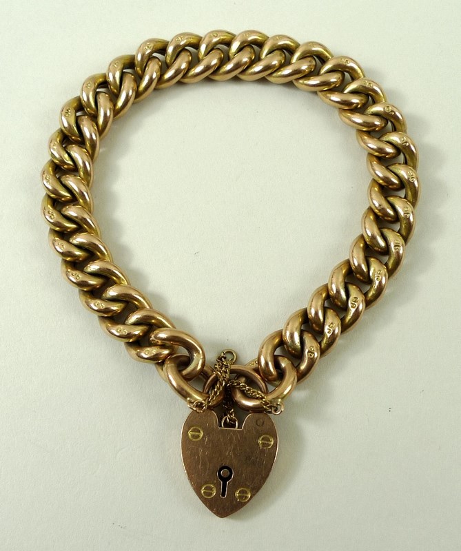 A 9ct gold link bracelet with pad lock clasp and safety chain, 20.2g.