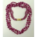 A double strand of pink sapphires, interspersed with seed pearls on a 9ct gold clasp,