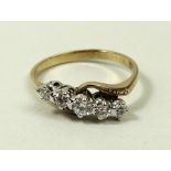 An 18ct gold and diamond crossover ring, set with five graduated diamonds, total approximately 0.