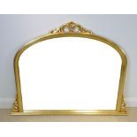 A modern Victorian style gilt overmantle mirror, with domed top and carved crest, 139 by 106cm high.