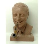 A 1950's tobacconists advertising plaster bust of a gentleman smoking a meerschaum pipe,