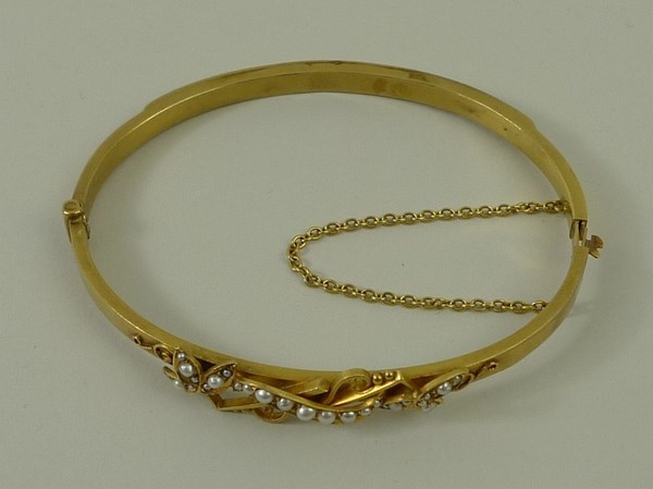 A 15ct yellow gold and natural seed pearl bangle, with trefoil and scroll motif, 12. - Image 2 of 4