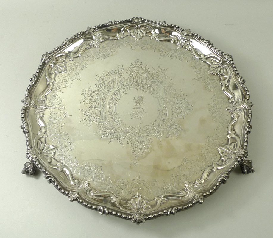 A silver salver, with cast bead and leaf rim, the reserve with a griffin, on ball and claw feet,