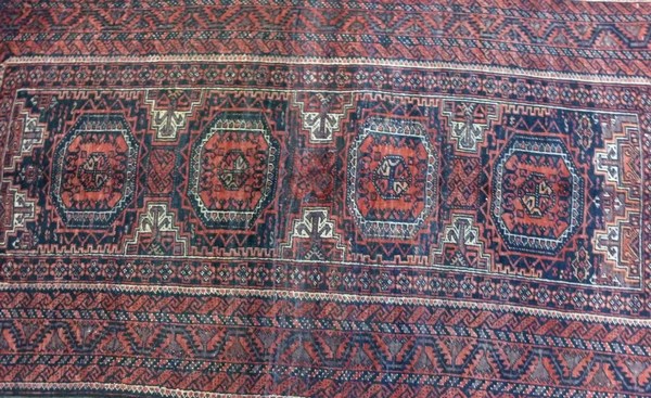 A Baluchi rug with dark red ground, four square medallions with canted corners, - Image 2 of 3