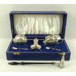 An Elizabeth II silver cruet set, comprising salt cauldron with blue glass liner,