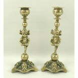 A pair of brass candlesticks modelled as Lincoln Imps, late 19th/early 20th century,