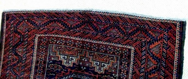 A Baluchi rug with dark red ground, four square medallions with canted corners, - Image 3 of 3