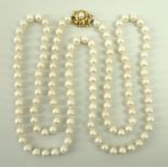 A string of pearls with an 18ct gold rope twist clasp set with a single pearl,