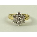 An 18ct gold and diamond flower head ring, with seven stones, each approximately 0.125ct, size M, 4.