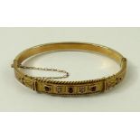 An Edwardian 9ct gold, diamond and ruby bangle,