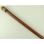 An Edwardian walking pipe-stick, with a screw holly wood top above the malacca cane, 93cm.